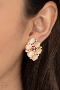 A glassy collection of dainty white rhinestones and peach cat's eye stones coalesce into a bubbly frame for a timeless look. Earring attaches to a standard clip-on fitting.
Sold as one pair of clip-on earrings. A glassy collection of dainty white rhinestones and peach cat's eye stones coalesce into a bubbly frame for a timeless look. Earring attaches to a standard clip-on fitting.
Sold as one pair of clip-on earrings.