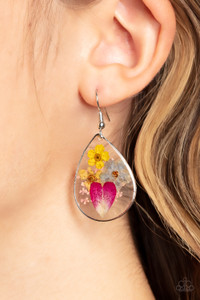 A colorful collection of wildflowers is encased inside a glassy teardrop casing bordered in silver, creating a whimsical display. Earring attaches to a standard fishhook fitting.

Sold as one pair of earrings.