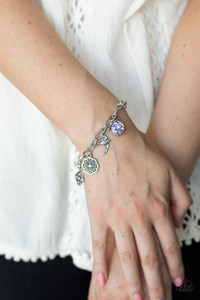 Sparkling purple gems, a floral medallion, a bird in flight, and a fluttering feather dangle from a delicate silver chain as they coalesce into a whimsical charm bracelet. Features an adjustable clasp closure.
Sold as one bracelet. Sparkling purple gems, a floral medallion, a bird in flight, and a fluttering feather dangle from a delicate silver chain as they coalesce into a whimsical charm bracelet. Features an adjustable clasp closure.
Sold as one bracelet.