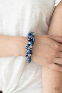 Dainty blue pearls and sparkly white crystal-like beads cluster between oversized blue pearls that are threaded along stretchy bands around the wrist, creating a stunning centerpiece.
Sold as one individual bracelet. Dainty blue pearls and sparkly white crystal-like beads cluster between oversized blue pearls that are threaded along stretchy bands around the wrist, creating a stunning centerpiece.
Sold as one individual bracelet.