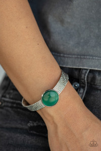 A glassy green cat's eye stone frame sits atop a layered silver cuff that is etched in shimmery textures, creating a glittery centerpiece.
Sold as one individual bracelet. A glassy green cat's eye stone frame sits atop a layered silver cuff that is etched in shimmery textures, creating a glittery centerpiece.
Sold as one individual bracelet.