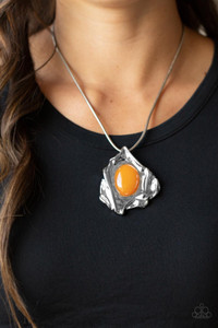 A glassy orange oval bead is pressed into the center of an abstract silver frame below the collar, creating a colorful artisan inspired pendant at the bottom of a rounded silver snake chain. Features an adjustable clasp closure.
Sold as one individual necklace. Includes one pair of matching earrings. A glassy orange oval bead is pressed into the center of an abstract silver frame below the collar, creating a colorful artisan inspired pendant at the bottom of a rounded silver snake chain. Features an adjustable clasp closure.
Sold as one individual necklace. Includes one pair of matching earrings.