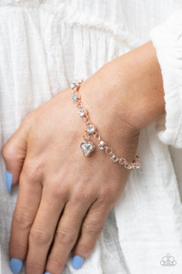 Brilliant white rhinestones in rose gold settings are linked together and accented with a charming white rhinestone heart that dangles sweetly from the wrist. Features an adjustable clasp closure.
Sold as one individual bracelet. Brilliant white rhinestones in rose gold settings are linked together and accented with a charming white rhinestone heart that dangles sweetly from the wrist. Features an adjustable clasp closure.
Sold as one individual bracelet.