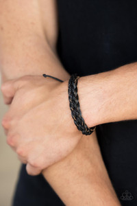Black cording is woven through the center of braided black leather creating a trendy style around the wrist. Features an adjustable sliding knot closure.

Sold as one individual bracelet.