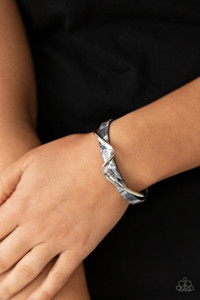A flat silver bar delicately curls across a dainty gray shell-like acrylic cuff, creating a whimsical centerpiece around the wrist.
Sold as one individual bracelet. A flat silver bar delicately curls across a dainty gray shell-like acrylic cuff, creating a whimsical centerpiece around the wrist.
Sold as one individual bracelet.
