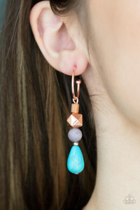 A charismatic collection of glassy, amethyst, and turquoise stone beads, accented with a shiny copper faceted square bead, are threaded onto a pin which dangles from a dainty shiny copper hoop. Earring attaches to a standard post fitting. Hoop measures approximately 3/4" in diameter.

Sold as one pair of hoop earrings.