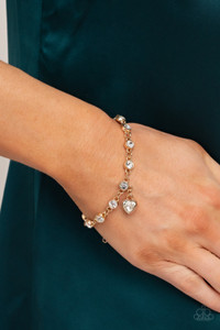 A white rhinestone heart charm dances from a strand of white rhinestones, resulting in a flirtatiously golden sparkle around the wrist. Features an adjustable clasp closure.
Sold as one individual bracelet. A white rhinestone heart charm dances from a strand of white rhinestones, resulting in a flirtatiously golden sparkle around the wrist. Features an adjustable clasp closure.
Sold as one individual bracelet.