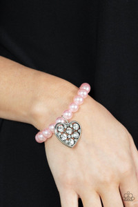 A dramatically oversized white rhinestone encrusted silver heart charm dangles from a stretchy strand of bubbly pink pearls, creating a flirtatious dazzle.
Sold as one individual bracelet. A dramatically oversized white rhinestone encrusted silver heart charm dangles from a stretchy strand of bubbly pink pearls, creating a flirtatious dazzle.
Sold as one individual bracelet.