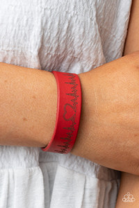 Culminating into a heart at the center, a zigzagging pattern reminiscent of a heartbeat is etched across the front of a red leather band around the wrist for a whimsical fashion. Features an adjustable snap closure.
Sold as one individual bracelet. Culminating into a heart at the center, a zigzagging pattern reminiscent of a heartbeat is etched across the front of a red leather band around the wrist for a whimsical fashion. Features an adjustable snap closure.
Sold as one individual bracelet.