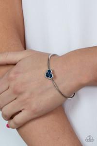 A studded silver heart is encrusted in emerald cut blue rhinestones, creating a flirtatious centerpiece atop a dainty silver cuff.
Sold as one individual bracelet. A studded silver heart is encrusted in emerald cut blue rhinestones, creating a flirtatious centerpiece atop a dainty silver cuff.
Sold as one individual bracelet.