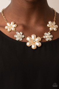 Featuring glassy white rhinestone centers, bubbly pearl petaled gold flowers gradually increase in size as they alternate with white rhinestone petaled flowers below the collar for a fierce floral fashion. Features an adjustable clasp closure.
Sold as one individual necklace. Includes one pair of matching earrings. Featuring glassy white rhinestone centers, bubbly pearl petaled gold flowers gradually increase in size as they alternate with white rhinestone petaled flowers below the collar for a fierce floral fashion. Features an adjustable clasp closure.
Sold as one individual necklace. Includes one pair of matching earrings.