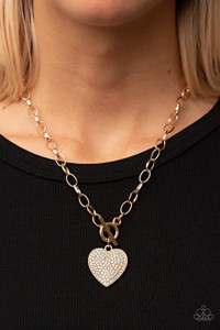 A blinding white rhinestone dotted gold heart frame sparkles from a toggle closure at the center of an oval gold linked chain for a flirtatious fashion. Features a toggle closure.
Sold as one individual necklace. Includes one pair of matching earrings. A blinding white rhinestone dotted gold heart frame sparkles from a toggle closure at the center of an oval gold linked chain for a flirtatious fashion. Features a toggle closure.
Sold as one individual necklace. Includes one pair of matching earrings.