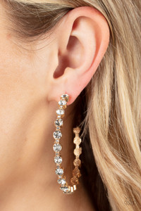 Encased in sleek gold fittings, a glamorous collection of glittery white rhinestones delicately coalesce into an oversized hoop for a sparkly statement. Earring attaches to a standard post fitting. Hoop measures approximately 2 1/2" in diameter.
Sold as one pair of hoop earrings. Encased in sleek gold fittings, a glamorous collection of glittery white rhinestones delicately coalesce into an oversized hoop for a sparkly statement. Earring attaches to a standard post fitting. Hoop measures approximately 2 1/2" in diameter.
Sold as one pair of hoop earrings.