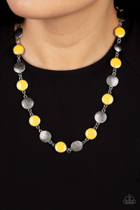 Shiny yellow discs bordered in silver frames alternate with antiqued silver discs brushed in linear texture. Connected by classic silver links, the discs create a stylish adornment below the collar. Features an adjustable clasp closure.
Sold as one individual necklace. Includes one pair of matching earrings. Shiny yellow discs bordered in silver frames alternate with antiqued silver discs brushed in linear texture. Connected by classic silver links, the discs create a stylish adornment below the collar. Features an adjustable clasp closure.
Sold as one individual necklace. Includes one pair of matching earrings.