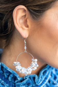 A timeless collection of iridescent crystal-like accents, dainty white pearls, and white floral frames delicately cluster along the bottom of a silver hoop, creating a glamorous glow. Earring attaches to a standard fishhook fitting.

Sold as one pair of earrings.