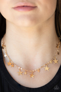 Varying in size, dainty shiny gold stars alternate along decorative gold chain, creating a stellar fringe below the collar. Features an adjustable clasp closure.
Sold as one individual necklace. Includes one pair of matching earrings. Varying in size, dainty shiny gold stars alternate along decorative gold chain, creating a stellar fringe below the collar. Features an adjustable clasp closure.
Sold as one individual necklace. Includes one pair of matching earrings.