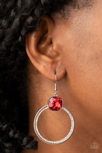 An oversized red gem sits atop a silver hoop with an inner ring encrusted in glitzy white rhinestones, resulting in a timeless twinkle. Earring attaches to a standard fishhook fitting.

Sold as one pair of earrings.
