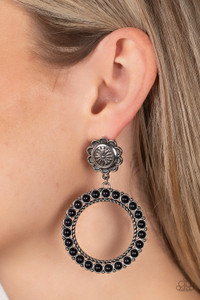 Featuring studded and twisted rope-like silver accents, a black stone dotted hoop swings from the bottom of a rustic silver flower for a whimsically floral fashion. Earring attaches to a standard post fitting.

Sold as one pair of post earrings.