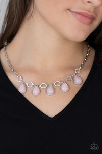 Encased in sleek silver frames, opaque pink teardrop beads link with dainty white rhinestone encrusted silver ovals below the collar, creating a mystical fringe. Features an adjustable clasp closure.
Sold as one individual necklace. Includes one pair of matching earrings. Encased in sleek silver frames, opaque pink teardrop beads link with dainty white rhinestone encrusted silver ovals below the collar, creating a mystical fringe. Features an adjustable clasp closure.
Sold as one individual necklace. Includes one pair of matching earrings.