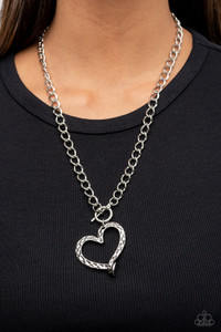 A hammered silver heart frame gently twists from a toggle closure at the bottom of a chunky silver chain, resulting in a romantically rustic pendant. Features a toggle closure.
Sold as one individual necklace. Includes one pair of matching earrings. A hammered silver heart frame gently twists from a toggle closure at the bottom of a chunky silver chain, resulting in a romantically rustic pendant. Features a toggle closure.
Sold as one individual necklace. Includes one pair of matching earrings.