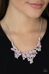 A bubbly collection of glowing pink cat's eye stones, glassy white rhinestones, and shiny silver discs delicately coalesces into enchanting frames below the collar that link into a whimsical centerpiece. Features an adjustable clasp closure.
Sold as one individual necklace. Includes one pair of matching earrings. A bubbly collection of glowing pink cat's eye stones, glassy white rhinestones, and shiny silver discs delicately coalesces into enchanting frames below the collar that link into a whimsical centerpiece. Features an adjustable clasp closure.
Sold as one individual necklace. Includes one pair of matching earrings.