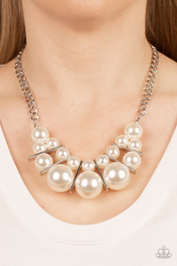 Separated by rectangular silver frames, bubbly rows of classic and oversized white pearls are threaded along invisible wires at the bottom of a chunky silver chain for an effervescent explosion below the collar. Features an adjustable clasp closure.

Sold as one individual necklace. Includes one pair of matching earrings.