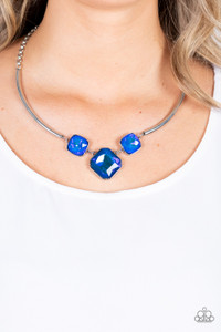 Featuring a subtle UV shimmer, an oversized collection of radiant cut blue gems delicately link at the bottom of two curved silver rods. Attached to shiny silver chains, the glamorously glitzy display sparkles below the collar for a jaw-dropping finish. Features an adjustable clasp closure.
Sold as one individual necklace. Includes one pair of matching earrings. Featuring a subtle UV shimmer, an oversized collection of radiant cut blue gems delicately link at the bottom of two curved silver rods. Attached to shiny silver chains, the glamorously glitzy display sparkles below the collar for a jaw-dropping finish. Features an adjustable clasp closure.
Sold as one individual necklace. Includes one pair of matching earrings.