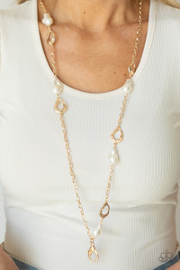 Asymmetrical hammered gold frames and imperfect pearly accents link with sections of classic gold chains across the chest, creating a rustic and refined statement piece. A lobster clasp hangs from the bottom of the design to allow a name badge or other item to be attached. Features an adjustable clasp closure.
Sold as one individual lanyard. Includes one pair of matching earrings. Asymmetrical hammered gold frames and imperfect pearly accents link with sections of classic gold chains across the chest, creating a rustic and refined statement piece. A lobster clasp hangs from the bottom of the design to allow a name badge or other item to be attached. Features an adjustable clasp closure.
Sold as one individual lanyard. Includes one pair of matching earrings.