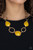 Delicately hammered in shimmery textures, asymmetrical gold rings and yellow beaded frames link below the collar for a colorful look. Features an adjustable clasp closure.
Sold as one individual necklace. Includes one pair of matching earrings. Delicately hammered in shimmery textures, asymmetrical gold rings and yellow beaded frames link below the collar for a colorful look. Features an adjustable clasp closure.
Sold as one individual necklace. Includes one pair of matching earrings.