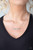 Dotted in dainty rhinestones that fade from white to dark blue, a dainty silver rectangular frame stamped in the word, "Mom", is suspended by a dainty silver chain below the collar for a charming look. Features an adjustable clasp closure.

Sold as one individual necklace. Includes one pair of matching earrings.