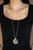 As if dipped in rhinestones, the bottoms of textured silver hoops are encrusted in glassy white rhinestones as they swing from the bottom of a white rhinestone encrusted fitting. A glowing orange cat's eye stone adorns the center, adding a tranquil splash of color to the hypnotizing pendant. Features an adjustable clasp closure.
Sold as one individual necklace. Includes one pair of matching earrings. As if dipped in rhinestones, the bottoms of textured silver hoops are encrusted in glassy white rhinestones as they swing from the bottom of a white rhinestone encrusted fitting. A glowing orange cat's eye stone adorns the center, adding a tranquil splash of color to the hypnotizing pendant. Features an adjustable clasp closure.
Sold as one individual necklace. Includes one pair of matching earrings.