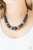 Dusted in glitter, sparkling gunmetal and pearly blue beads are threaded along an invisible wire below the collar for a glamorous look. Features an adjustable clasp closure.

Sold as one individual necklace. Includes one pair of matching earrings.