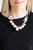 Capped in glistening gunmetal fittings, oversized pink beads and a collection of classic silver or pink beads swing from the bottom of a shimmery silver chain, creating a bubbly fringe below the collar. Features an adjustable clasp closure. Capped in glistening gunmetal fittings, oversized pink beads and a collection of classic silver or pink beads swing from the bottom of a shimmery silver chain, creating a bubbly fringe below the collar. Features an adjustable clasp closure.