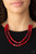 Infused with dainty silver beads, a collection of glassy and polished red crystal-like beads are threaded along two invisible wires, creating glamorous layers below the collar. Features an adjustable clasp closure.

Sold as one individual necklace. Includes one pair of matching earrings.