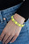 Clustered yellow beaded frames are threaded along stretchy bands around the wrist, creating a bubbly look.

Sold as one individual.