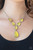 A series of yellow cat's eye teardrops interlock at the bottom of a silver chain, giving way to an oversized teardrop pendant for a refined finish. Features an adjustable clasp closure.

Sold as one individual necklace. Includes one pair of matching earrings.