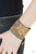 Painted in a colorfully distressed floral pattern, a thick cork-like leather band wraps around the wrist for a statement-making look. Features an adjustable snap closure. Painted in a colorfully distressed floral pattern, a thick cork-like leather band wraps around the wrist for a statement-making look. Features an adjustable snap closure.