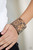 Painted in a tiled textile pattern, a thick cork-like leather band wraps around the wrist for a statement-making look. Features an adjustable snap closure.
Sold as one individual bracelet. Painted in a tiled textile pattern, a thick cork-like leather band wraps around the wrist for a statement-making look. Features an adjustable snap closure.
Sold as one individual bracelet.