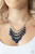 Featuring faceted finishes, blue beaded tassels drip from the bottom of a classic row of glittery white rhinestones. The shimmery blue teardrops gradually increase in size at the center as they taper below the collar, creating a flirtatious fringe. Features an adjustable clasp closure.

Sold as one individual necklace. Includes one pair matching earrings.
