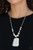 Swinging from the bottom of a shimmery silver chain, a collection of ornate silver accents and refreshing white stone beads are threaded along an invisible wire below the collar. A flat, oversized white stone pendant swings from the bottom for a statement-making finish. Features an adjustable clasp closure.

Sold as one individual necklace. Includes one pair of matching earrings.