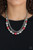 Layers of mismatched silver chains give way to a strand of ornate silver beads and oversized red pearls that cascade below the collar for a refined flair. Features an adjustable clasp closure.

Sold as one individual necklace. Includes one pair of matching earrings.