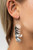 A cluster of bubbly silver sequins dangle from the ear, creating effortless effervescence. Earring attaches to a standard fishhook fitting.

Sold as one pair of earrings.