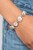 Gradually increasing in size at the center, a dramatic row of exaggerated white rhinestone encrusted silver frames delicately link around the wrist for a statement-making sparkle. Features an adjustable clasp closure.
Sold as one individual bracelet. Gradually increasing in size at the center, a dramatic row of exaggerated white rhinestone encrusted silver frames delicately link around the wrist for a statement-making sparkle. Features an adjustable clasp closure.
Sold as one individual bracelet.