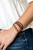 Infused with dainty silver and refreshing orange stone beads, mismatched strands of braided twine-like cord and brown leather pieces delicately layer across the wrist for a colorfully earthy look. Features an adjustable sliding knot closure.
Sold as one individual bracelet. Infused with dainty silver and refreshing orange stone beads, mismatched strands of braided twine-like cord and brown leather pieces delicately layer across the wrist for a colorfully earthy look. Features an adjustable sliding knot closure.
Sold as one individual bracelet.