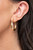 A thick gold bar curls into a dainty crescent shaped hoop for a classic finish. Earring attaches to a standard post fitting. Hoop measures approximately 1" in diameter.

Sold as one pair of hoop earrings.