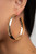 A thick piece of gold has been heavily hammered and delicately curved into a dramatically handcrafted hoop. Earring attaches to a standard post fitting. Hoop measures approximately 2 ½” in diameter.

Sold as one pair of hoop earrings.