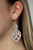 Encrusted in glassy white rhinestones, ribbons of shimmery silver loop into an ornate frame for a refined flair. Earring attaches to a standard fishhook fitting.

Sold as one pair of earrings.