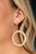 Encrusted in a glittery ring of white rhinestones, a studded gold hoop swings from the ear for a dramatic look. Earring attaches to a standard fishhook fitting.

Sold as one pair of earrings.