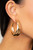 Two thick gold bars delicately overlap into a boldly oversized hoop. Earring attaches to a standard post fitting. Hoop measures approximately 2" in diameter.

Sold as one pair of hoop earrings.