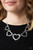 Gradually increasing in size, glistening silver heart silhouettes delicately link below the collar in a charming fashion. Features an adjustable clasp closure.

Sold as one individual necklace. Includes one pair of matching earrings.